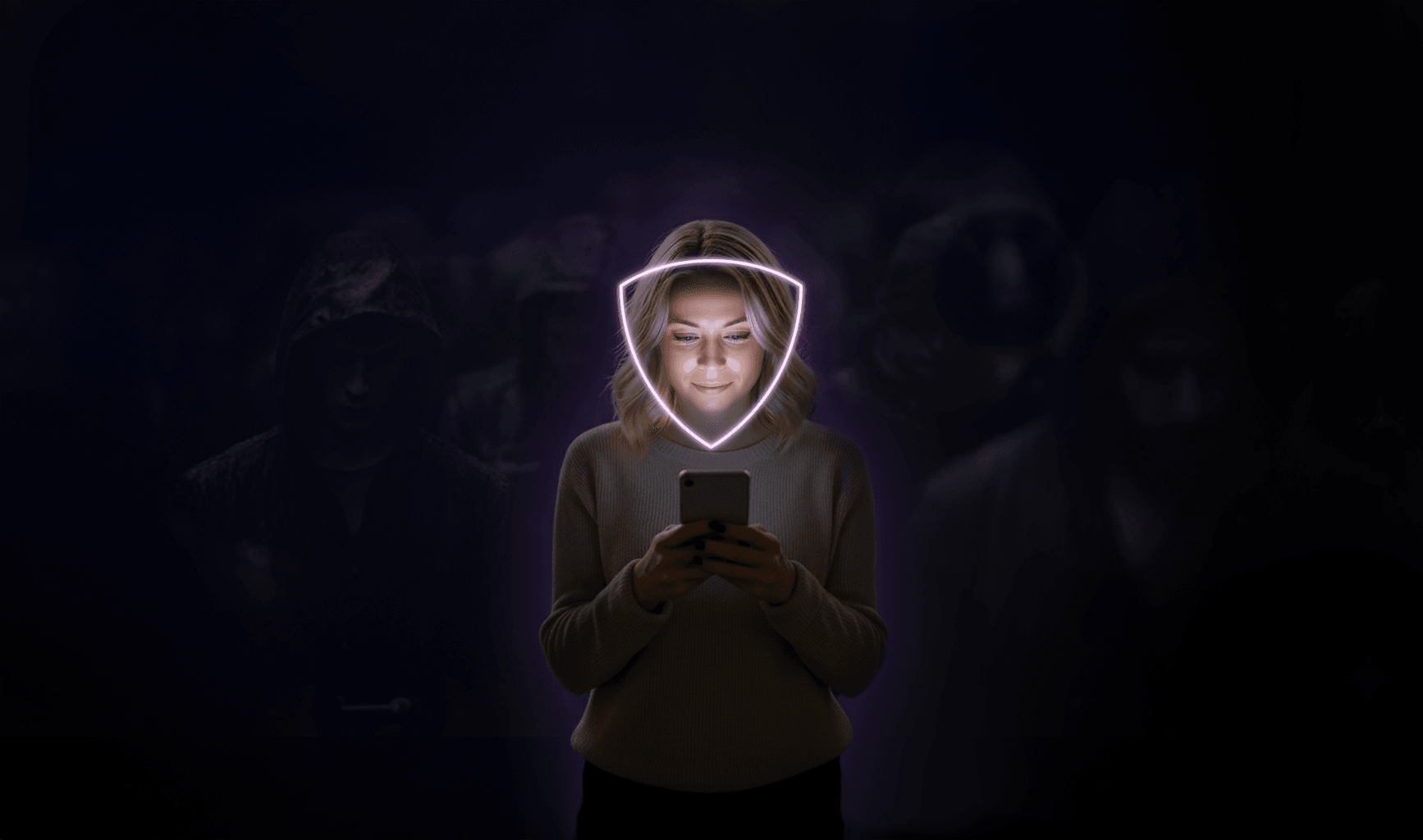 A woman looking at her phone, her face ringed by a glowing shield, with anonymous hooded figures fading into the dark behind her.